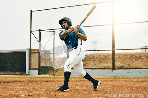 Image of Baseball man, stadium game or hit ball with bat on a sport field in a game. Sports player with practice, strike and concentration to win match by competitive male batter focus during training outdoor