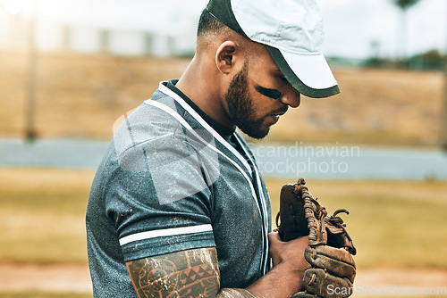 Image of Man, baseball and glove with focus, game and determination as fielder, pitcher or baseball player. Athlete, sport and training for wellness, fitness and health in competition, sports or match outdoor