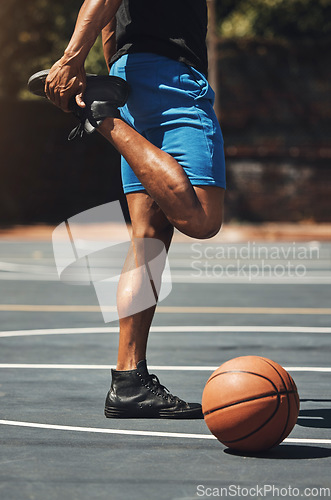 Image of Fitness, basketball and man stretching legs on outdoor court for muscle preparation with workout. Muscular, strong and athlete male with standing warm up for sports game training exercise.