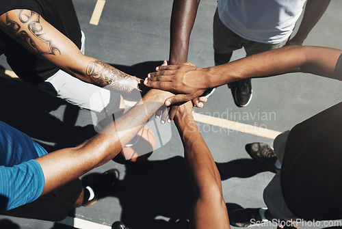 Image of Hands, team and basketball in support, trust and coordination above for unity on the outdoor court. Hand of people in sports teamwork piling together for motivation and collaboration to win game