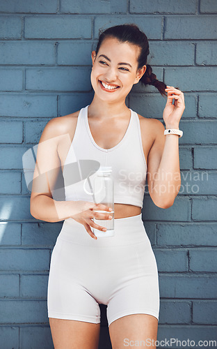 Image of Fitness, exercise and water with a sports woman taking a drink during a break from her training workout. Health, cardio and hydration with a female athlete or runner thinking about her wellness