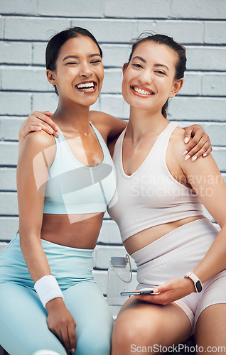 Image of Women, hug and phone in city fitness, workout and training with heart cardio app, wellness motivation and exercise goals. Portrait, smile or happy sports friends bonding with mobile health technology