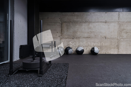 Image of An empty modern gymnasium with a variety of equipment, offering a spacious, functional, and well-equipped training facility for workouts, fitness, and strength training