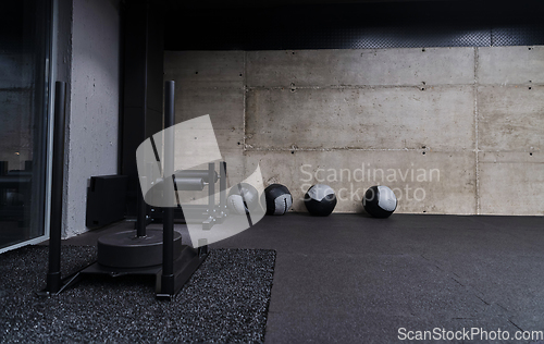 Image of An empty modern gymnasium with a variety of equipment, offering a spacious, functional, and well-equipped training facility for workouts, fitness, and strength training