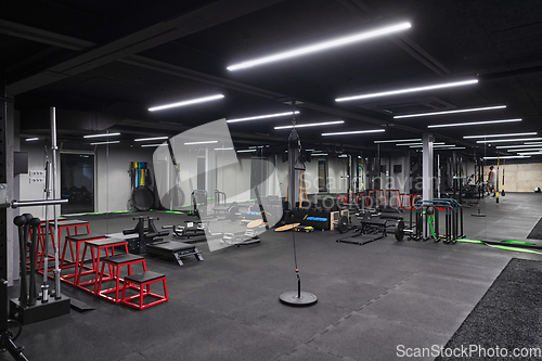 Image of An empty modern gymnasium with a variety of equipment, offering a spacious, functional, and well-equipped training facility for workouts, fitness, and strength training