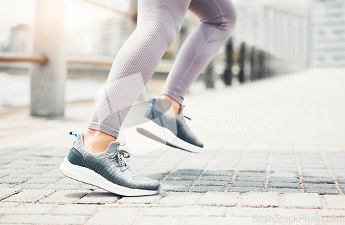 Image of Running shoes, feet sneakers and city cardio exercise, marathon and sports training in urban outdoor. Closeup woman athlete foot, legs and fast running speed of healthy fitness runner sprint movement