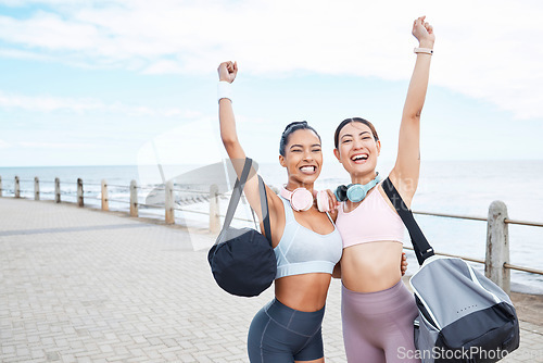 Image of Fitness, runner friends portrait for success at beach sidewalk with victory hand in Los Angeles. Running, training and workout goal achievement with happy and proud women celebrating progress.