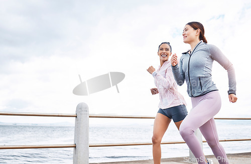 Image of Running, fitness and friends, women run by the beach, exercise and cardio, endurance and active lifestyle. Young, happy people, runner and health, body training motivation and workout outdoors.