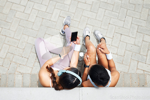Image of Smartphone, headphones and fitness friends listening to music, exercise podcast and health app for outdoor motivation. Relax sports people using phone for social media workout tips or blog app above