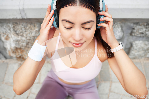 Image of Yoga, headphones and woman listening to music for zen, calm and peace meditation in the city. Health, fitness and girl from Canada doing a pilates exercise with wellness audio, podcast or radio.