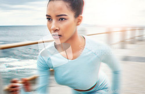 Image of Fast, fitness and woman running in nature for cardio health, wellness and sports motivation by the ocean. Face of an athlete runner with speed, training and doing a workout for exercise by the sea