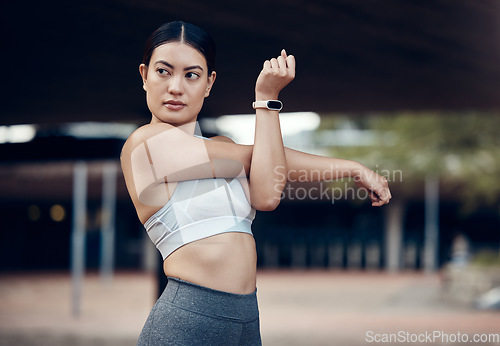 Image of Fitness, woman and stretching in the city for workout, exercise and cardio in the outdoors. Active female in sports stretch for healthy training, warm up or exercising in an urban town