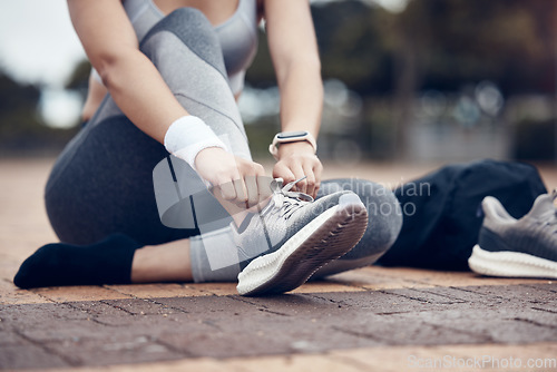 Image of Fitness, runner and woman with shoe lace in sports motivation for workout, exercise or training in the outdoors. Female tying shoes for a run in healthy sport for cardio exercising in a urban town