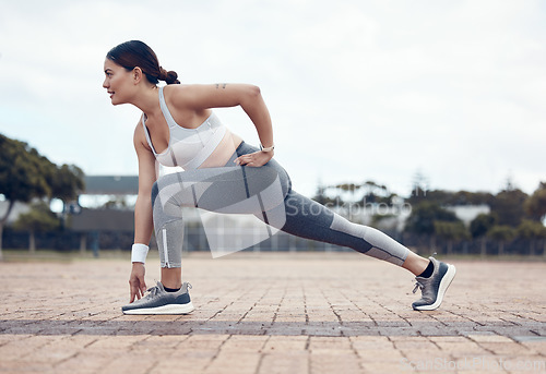 Image of City woman stretching, fitness and running warm up for outdoor cardio marathon run workout. Motivation, focus and commitment for athletic flexibility training exercise to improve body health wellness