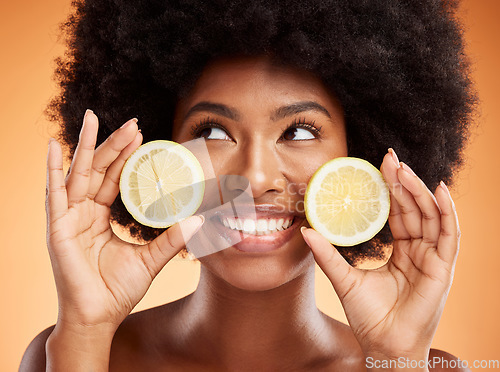 Image of Beauty, skincare and black woman with lemon in hands and smile on face posing for organic, healthy and natural ingredients in skincare products. Facial, body care and wellness for spa detox treatment