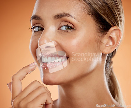 Image of Woman beauty, sugar scrub lips and facial skincare cosmetics for mouth, makeup and face aesthetic on studio background. Portrait of happy model exfoliate, cleaning and natural peeling lipstick mask