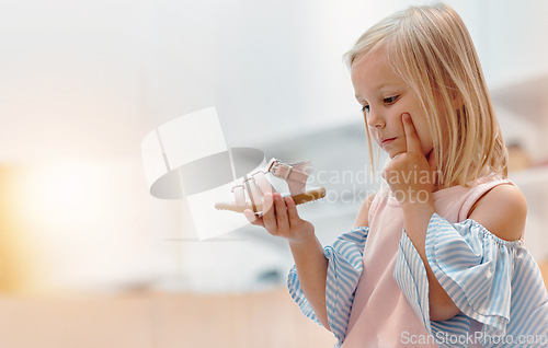 Image of Children, shoes and fashion with a girl thinking about a choice in a retail store or mall while shopping. Kids, idea and customer with a female child deciding on a footwear purchase with mockup