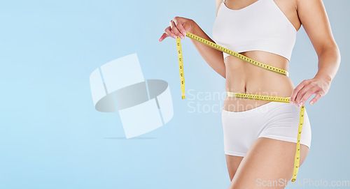 Image of Tape measure, stomach and woman health diet, fitness and detox weight goals, target and abdomen on mockup blue background. Liposuction, tummy tuck and wellness model, bmi progress and skinny body fat