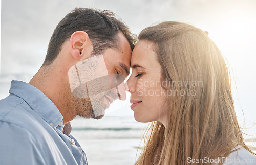 Image of Travel, love and couple relax at sunset, embracing in intimate moment on a beach vacation in Florida. Happy, face and caring man relaxing with woman in Mexico, enjoy romance and ocean trip together