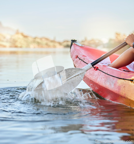 Image of Calm lake, water sport and woman on kayak adventure for summer travel trip canoeing, kayaking and using paddle on river. Exercise, vacation or holiday with female enjoying rafting or boat activity