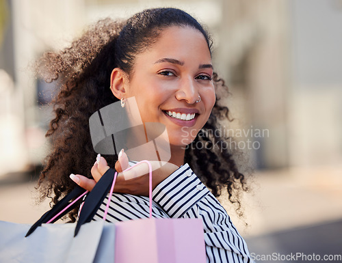 Image of Shopping bag, city and black woman with retail sales, discount or wealth portrait for fashion, clothes or cosmetics. Rich, success and happy young gen z customer shopping in an urban street mall