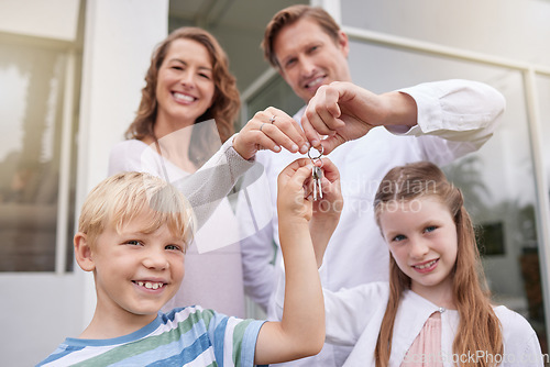 Image of Real estate, property and people with keys of family home, house or building while relax, happy and smile. Love, happiness and new homeowner portrait of mother, father and children moving in