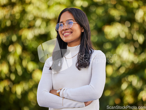 Image of Thinking, smile and woman with vision in nature during travel, freedom and holiday in New Zealand. Young, happy and girl with idea, arms crossed and pride in a park or garden to relax on vacation