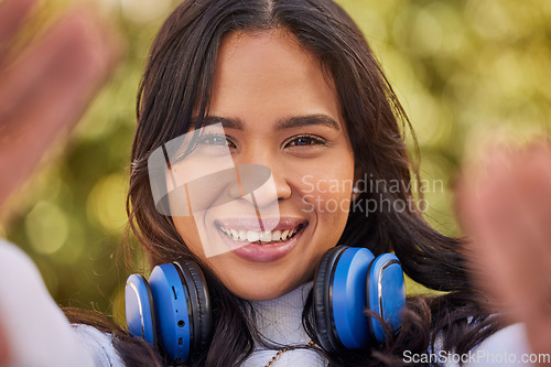 Image of Selfie portrait of young Indian woman, happy outdoor freedom and weekend lifestyle in Indonesia. Gen z hipster girl streaming podcast, video call of face or relax smile in nature with cool music