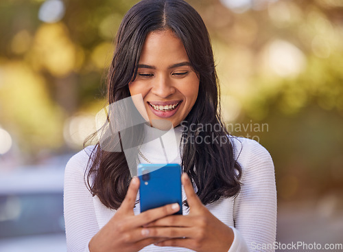 Image of Social media, phone and woman in the city for business, working and reading communication on a mobile. Happy, smile and young girl typing on a mobile app with 5g technology on the web in the street