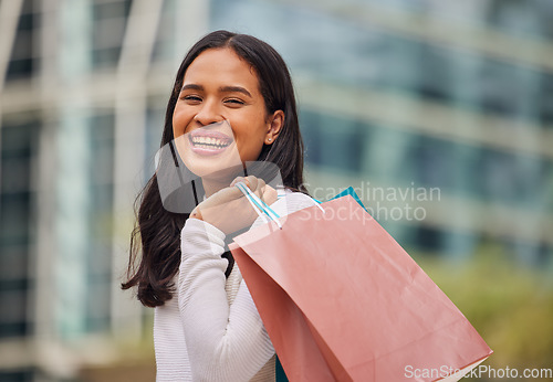 Image of Shopping, retail and city with a woman customer carrying bags while on the search for a sale, bargain or discount. Money, gift and store with a female shopper outdoor at a street mall for consumerism