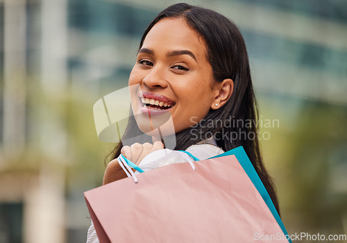 Image of Shopping bag, retail and woman in the city for a sale in New York for a discount or store at a mall. Face portrait of a happy, young and rich girl with bags after shopping during luxury sales in town