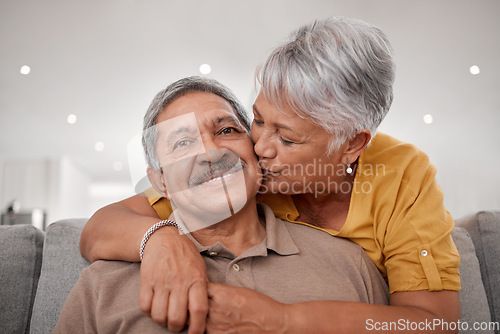 Image of Senior couple, hug and kiss while bonding on sofa in house or Mexico home living room in safety, love or security. Portrait, smile and happy retirement elderly man and woman with life insurance trust