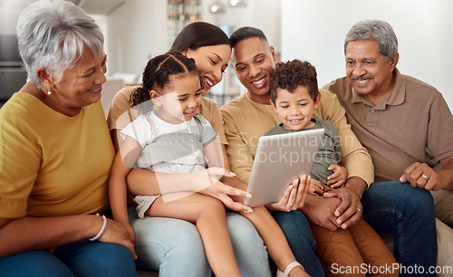 Image of Technology, children and family with tablet on home sofa for elearning, online education and internet game with men and women. Happy grandparents, mom and dad help kids read ebook on learning website