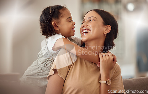 Image of Happy mama with girl child, hug in home and weekend play time lifestyle for mom parent. Funny crazy kid in living room, mother holding toddler with smile and love bonding together on mothers day