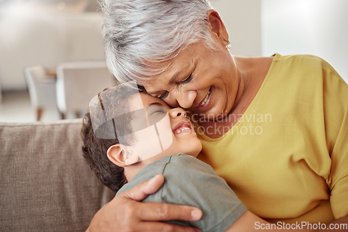Image of Happy family, child and grandma hug and bond in living room together, happy and content in their home. Relax, smile and love of boy hugging senior woman showing love and having fun in brazil house