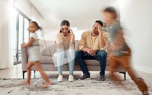 Image of Headache, noise and stress with family in living room and parents overwhelmed by adhd kids energy. Tired, burnout and man, woman and hyper active children running in house, having fun or playing game