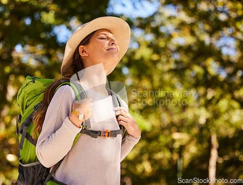 Image of Hiking, travel and woman backpacking in the forest for outdoor wellness, adventure or eco friendly lifestyle. Breathing, trekking and carbon footprint girl with backpack gear in woods, park and trees