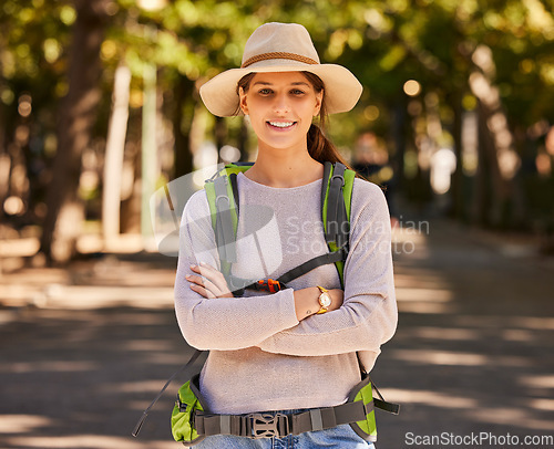 Image of Portrait, hiking and woman in hat arms crossed on holiday, vacation or trip. Travel, freedom and female from Canada on hike, explore or adventure outdoors in nature, having fun or spending time alone