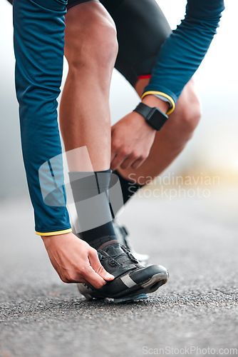 Image of Road, cycling shoes and man cyclist on a fitness trip for a marathon in the city for training. Sports, exercise and male athlete on outdoor cycle for a cardio workout in the street of an urban town.