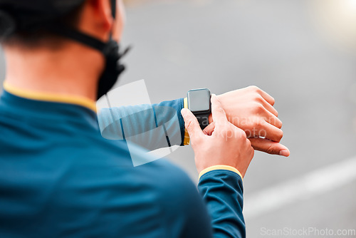 Image of Watch, fitness and man doing a workout, exercise or outdoor cardio in the city road for motivation. Hands of an athlete with monitor of time during training with sports technology in the street