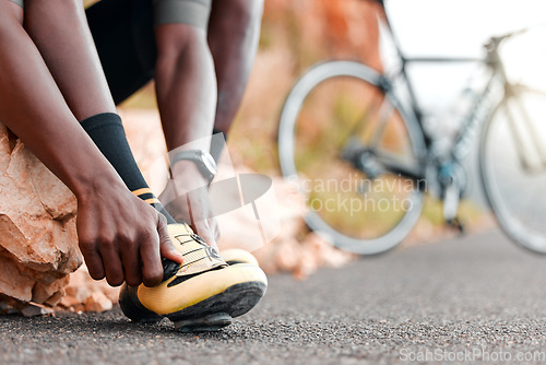 Image of Fitness, ready and man with cycling shoes by his bicycle starting his workout, cardio exercise and training journey. Sports, healthy and African athlete biker wearing cleats for a road adventure