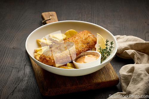 Image of bowl of breaded fish fillet and fried potato wedges