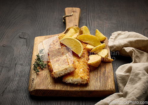 Image of breaded fish fillets and fried potato wedges