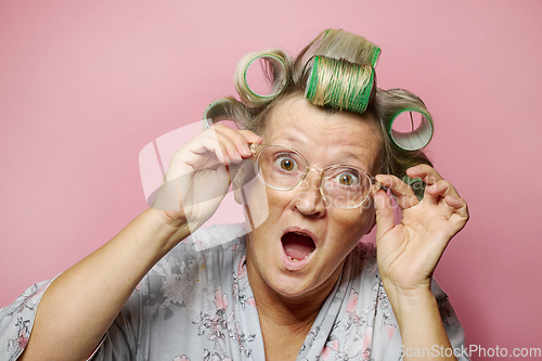 Image of surprised senior women with hair rollers