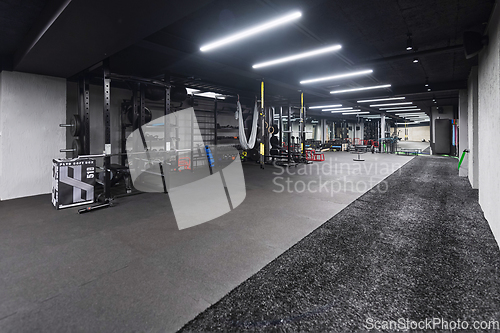 Image of An empty modern gymnasium with a variety of equipment, offering a spacious, functional, and well-equipped training facility for workouts, fitness, and strength training