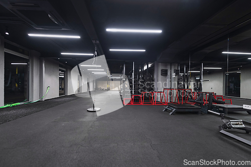 Image of An empty modern gymnasium with a variety of equipment, offering a spacious, functional, and well-equipped training facility for workouts, fitness, and strength training