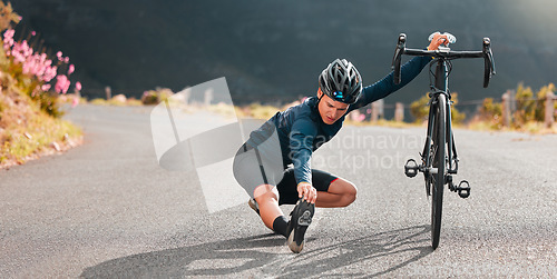 Image of Cycling, stretching and street with a sports man stopping on an asphalt road for a stretch during a ride. Bicycle, helmet and prepare with a male athlete outdoor for bike fitness or exercise