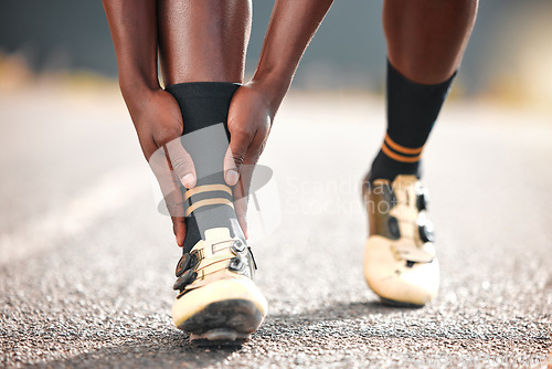 Image of Foot, pain and man in the road for fitness, cardio or exercise with a medical emergency in the city. Feet, legs and athlete runner training for sports in the road with an injury from a workout or run