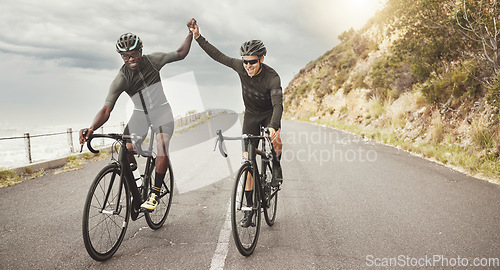 Image of Fitness, high five and friends cycling on the road for cardio exercise, sports training and bicycle workout. Successful, diversity and happy athletes or bikers riding by mountain with pride together