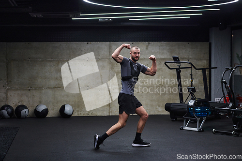Image of Muscular man posing in a modern gym